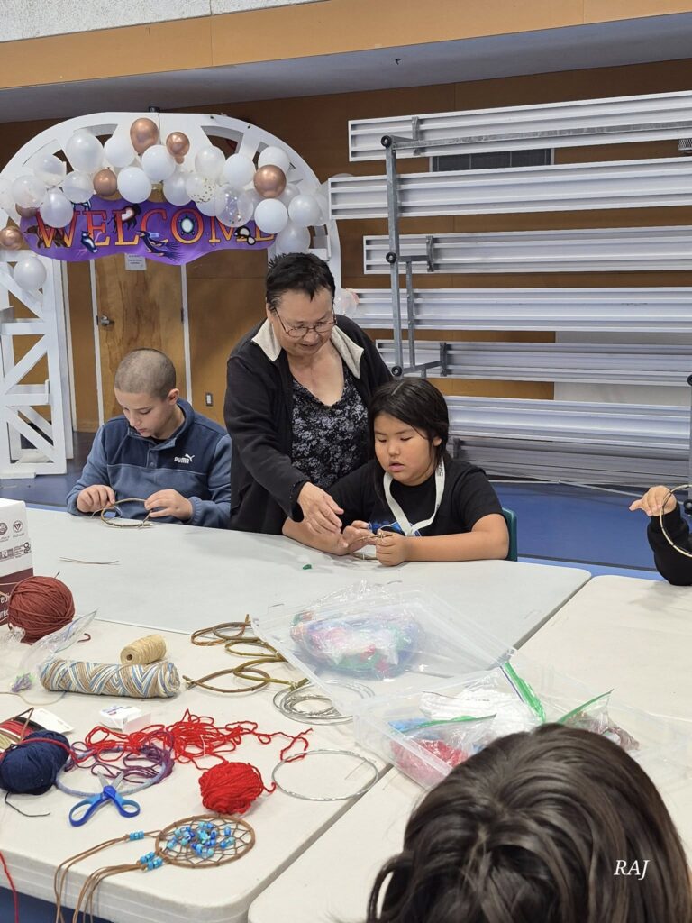 Children participate in a craft activity, guided by an adult