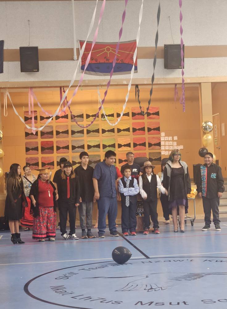 Students and community members gather in a decorated gymnasium for a cultural event