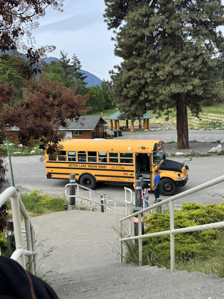 Yellow school bus for Seton Lake Indian Band parked at a community center